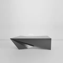 A perspective rendering shows the dark angular desk isolated against a pale background.